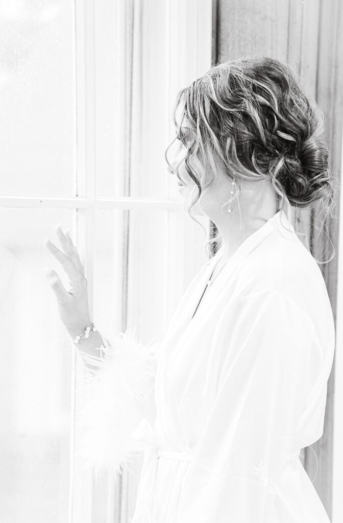 bride portrait black and white gazing out window