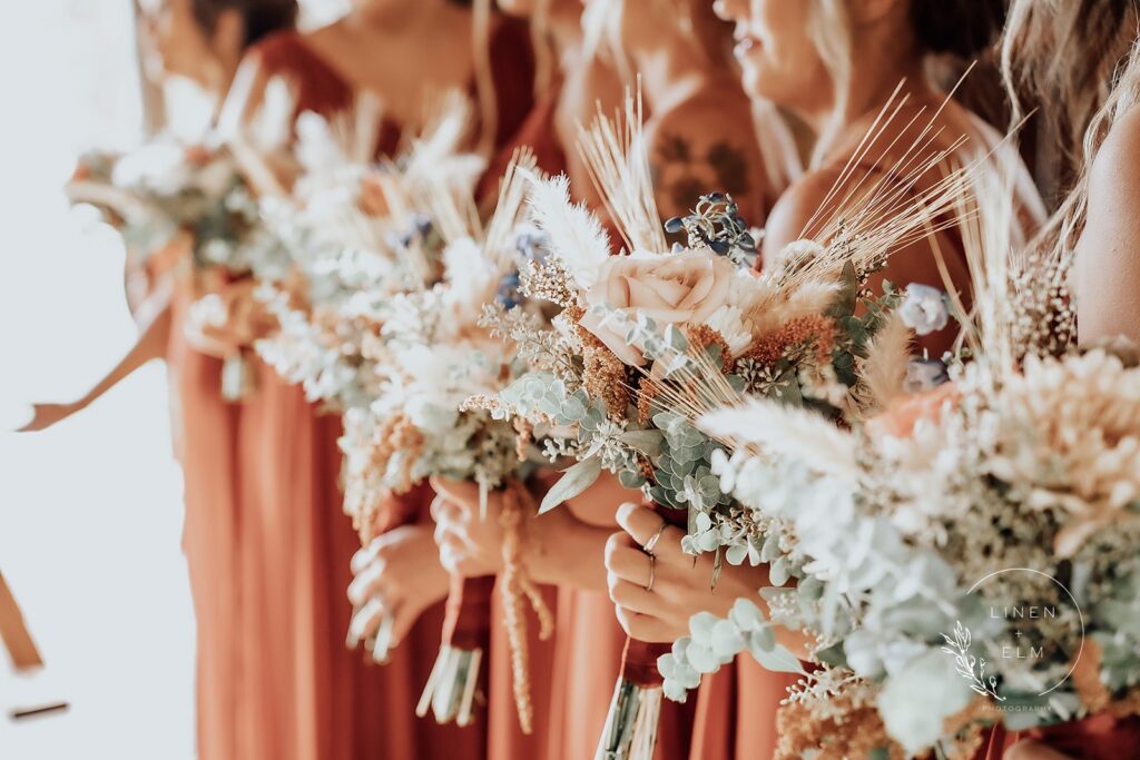 Bridesmaids Holding Flowers In A Row