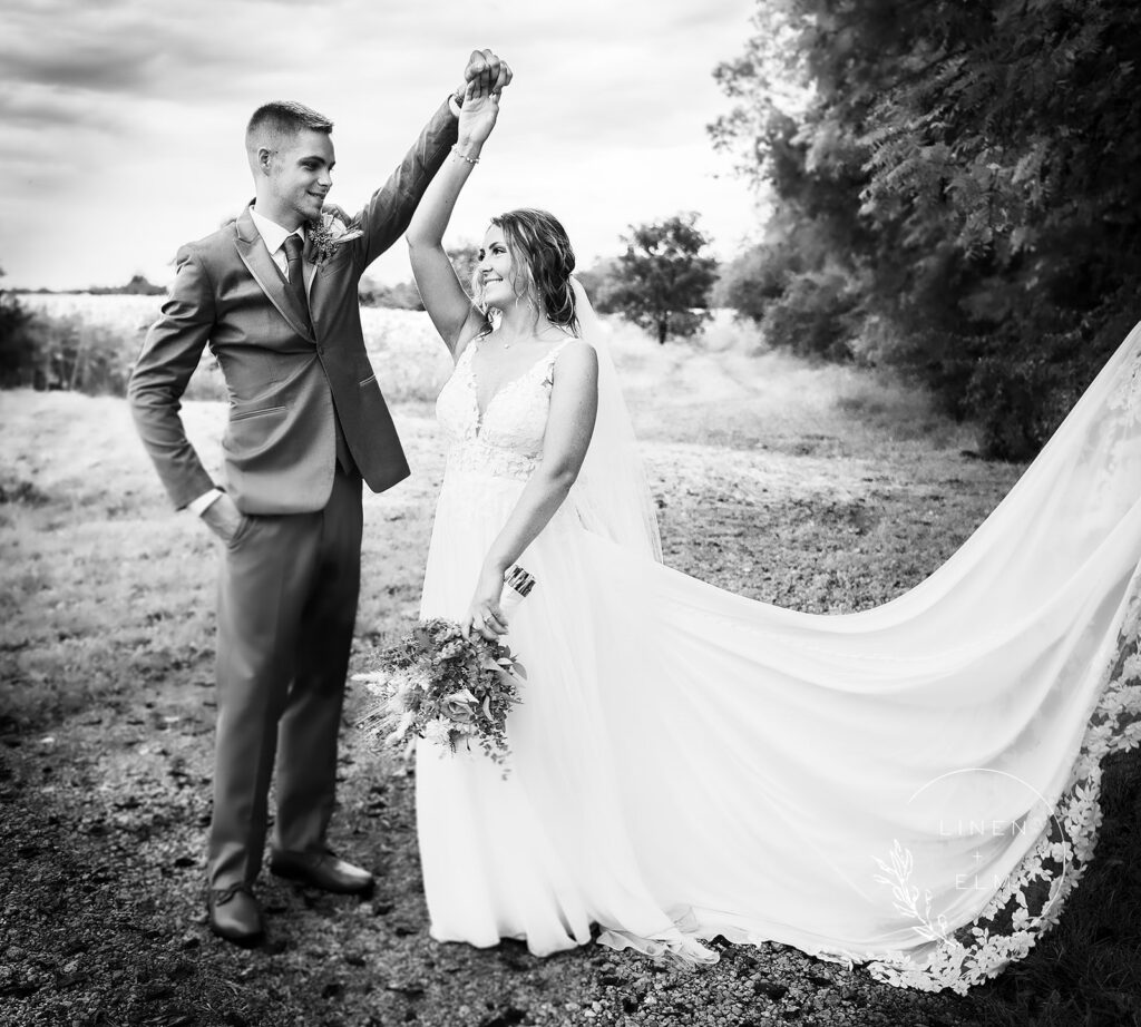 Wedding day black and white groom twirling bride