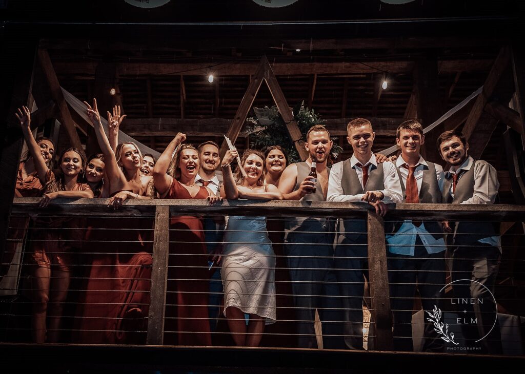 bridal party after reception on balcony
