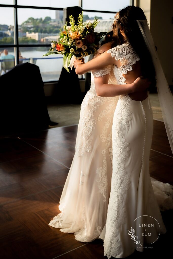 Two brides embracing after first look Cincinnati lbgtq wedding photography