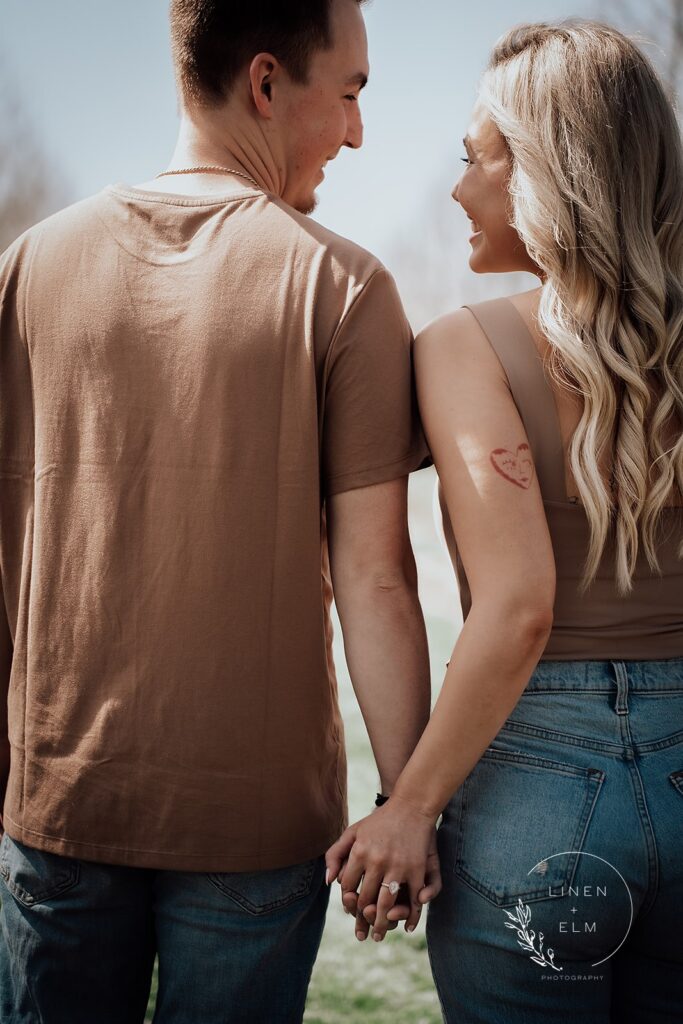 Couple backs to camera with ring in frame Engagement Photography Cox Arboretum Dayton Ohio 4 |