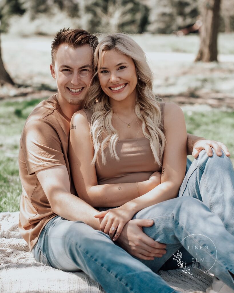 Couple embracing sitting on blanket