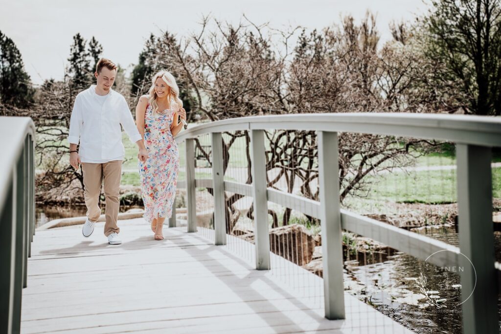 Couple Laughing And Walking Across Bridge Engagement Photography