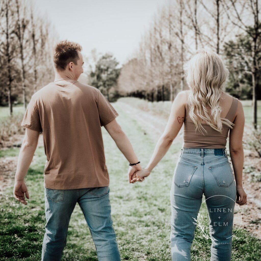 Engaged couple walking away looking at each other