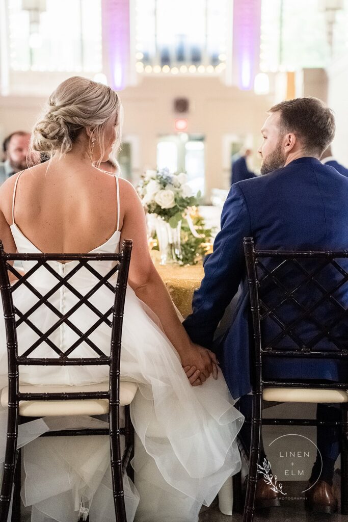 Bride and Groom at Reception Holding Hands Dayton Wedding Photographer