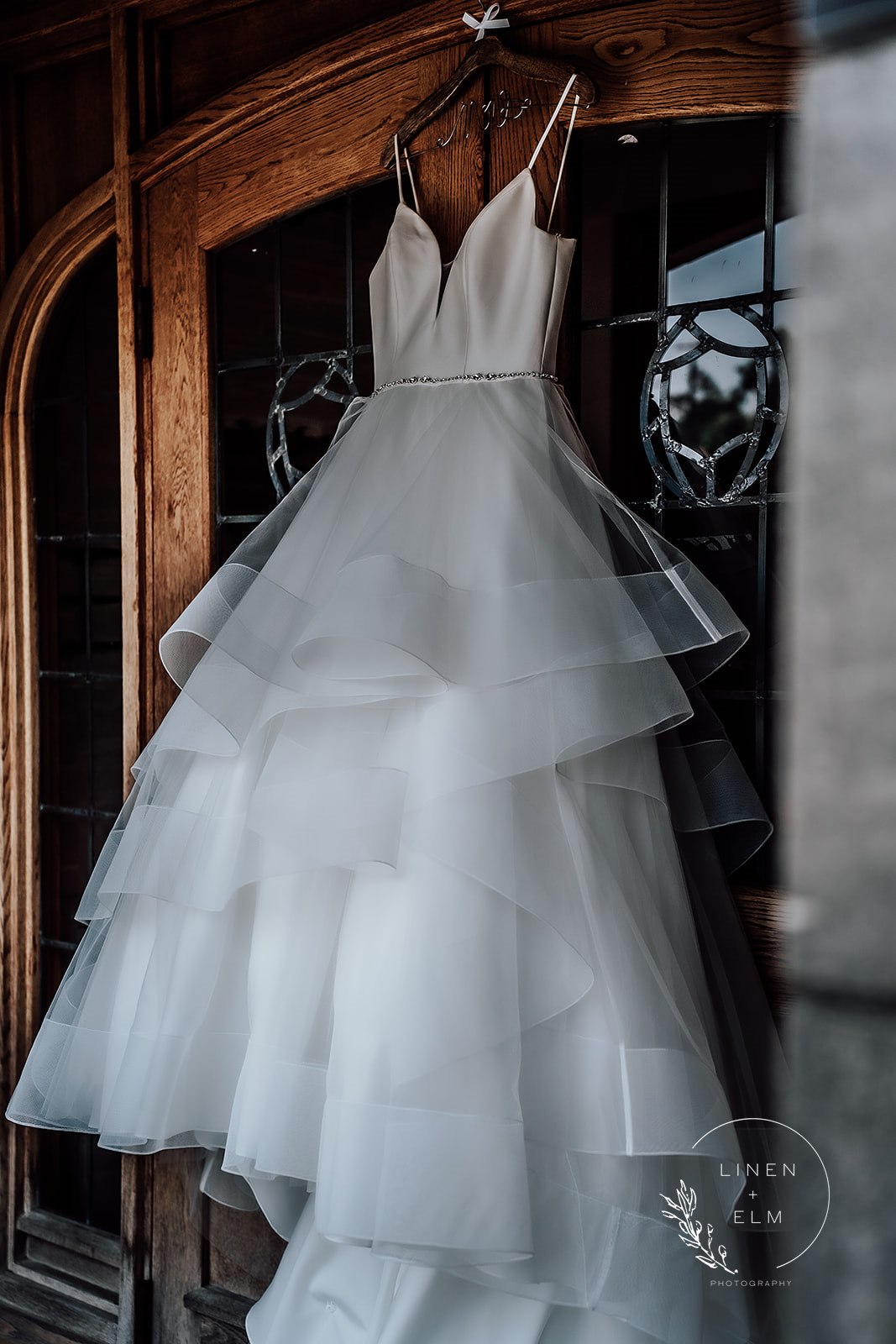 Brides dress hanging in doorway Dayton Wedding Photographer