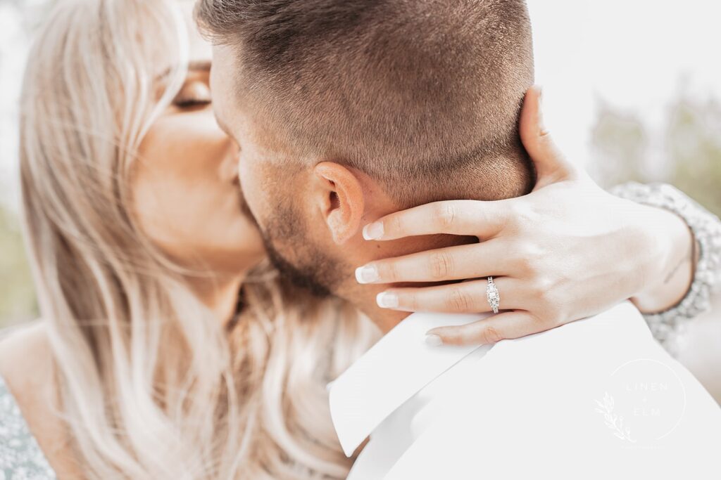 Close up photo of ring with engaged couple kissing, Bright Rustic Engagement Session Dayton Ohio