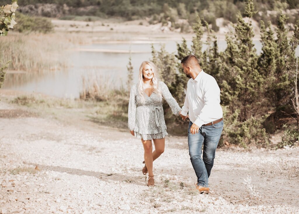 Bright Sunlight On Woman Being Led By Fiancé In Ohio Park During Engagement Session, Bright Rustic Engagement Session Dayton Ohio