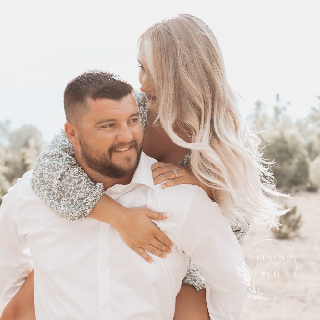 Couple having fun in Ohio park with sunlight shining down on them, Bright Rustic Engagement Session Dayton Ohio