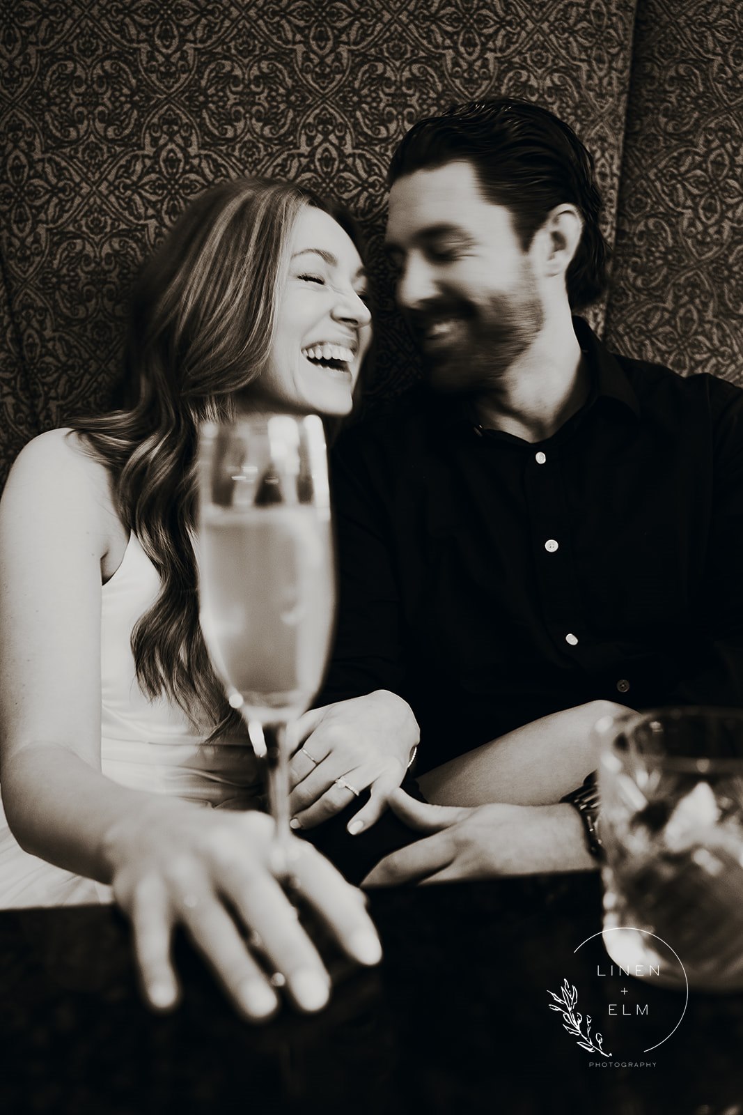 Couple Laughing Over Drinks At Hilton Netherland Hotel Cincinnati Engagement Photography