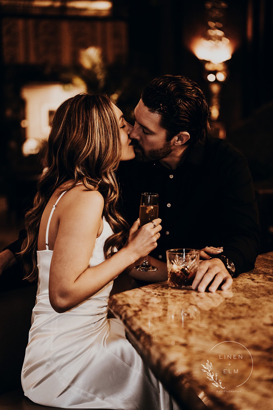 Couple kissing at bar Hilton Netherland Hotel Cincinnati engagement photography