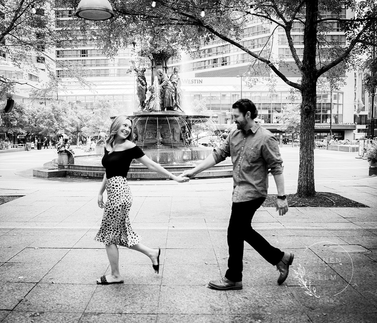 Couple walking in front of Fountain Square Cincinnati